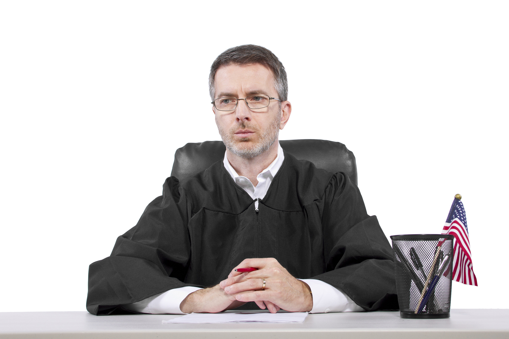 middle aged caucasian american judge in a robe sitting